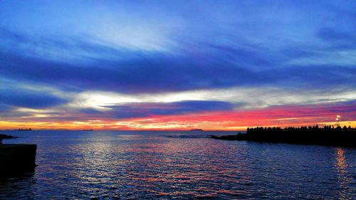 Scenic view of sea against romantic sky at sunset