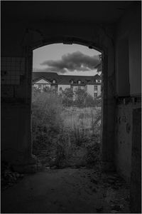 Abandoned house against cloudy sky