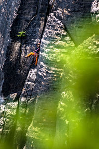 Distant view of man rock climbing 