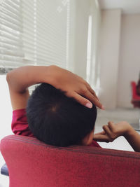 Rear view of a boy at home