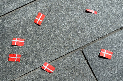 Directly above shot of danish flags falling on footpath