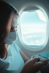 Midsection of woman holding window in sea