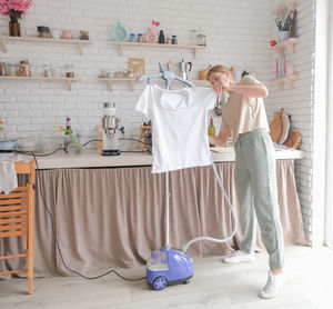 Full length of female friends standing on table