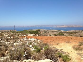 Scenic view of calm sea against clear blue sky