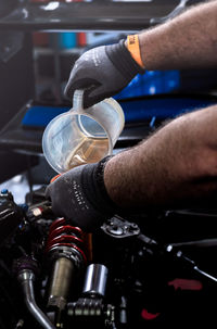 Cropped hand of man repairing car