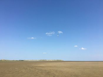 Scenic view of field against blue sky