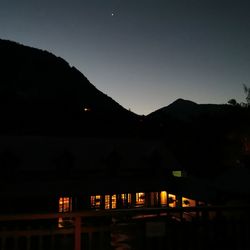 Silhouette built structure against sky at night