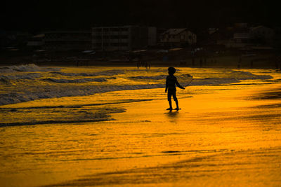 Silhouette woman walking on beach