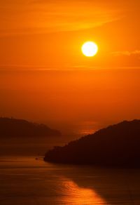 Scenic view of sea against romantic sky at sunset