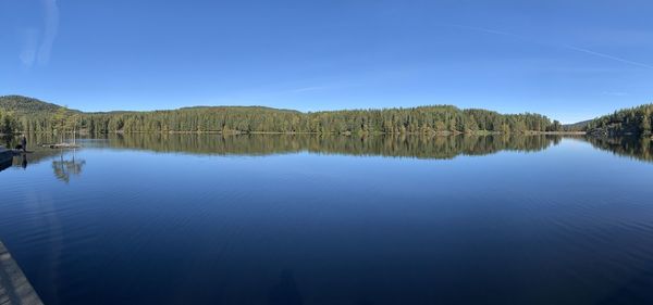 Scenic view of lake against blue sky