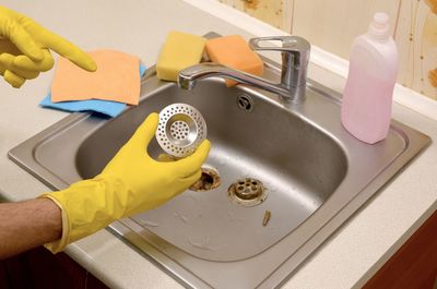 High angle view of man cleaning sink at home