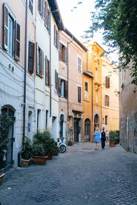 People on street amidst buildings in city