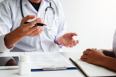 Midsection of doctor examining patient in hospital