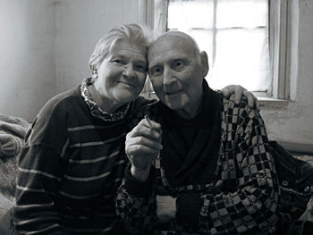 Portrait of senior couple sitting at home