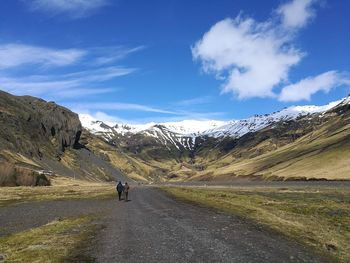 Road amidst mountains against sky