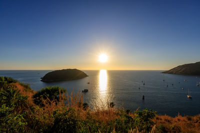 Beautiful sunset on andaman sea at windmill view point near laem promthep cape, phuket, thailand