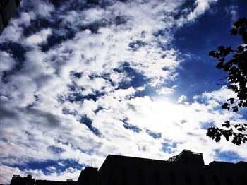 Low angle view of building against cloudy sky