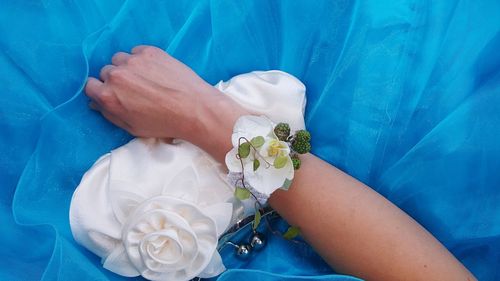 Low section of woman with hand holding bouquet