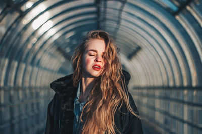 Portrait of a beautiful young woman standing outdoors