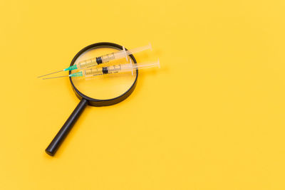 Close-up of clock on yellow background