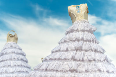 Low angle view of wedding dresses against sky