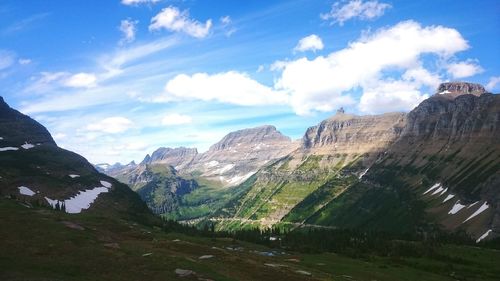 Scenic view of mountains against cloudy sky