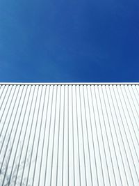 Low angle view of white building against clear blue sky