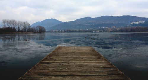 Pier over lake against sky