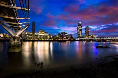 Illuminated buildings in city at dusk