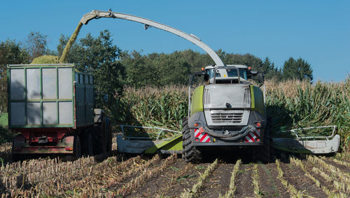 Tractor on field against clear sky
