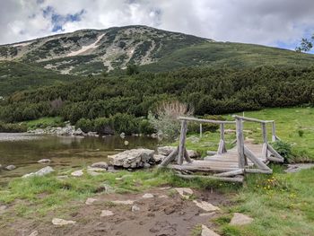 Scenic view of lake and mountains against sky