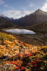 Scenic view of lake and mountains against sky