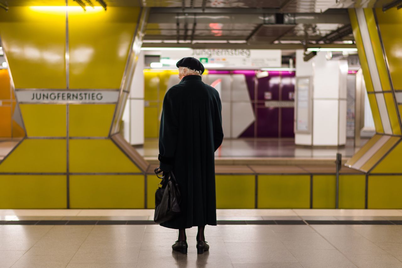 indoors, men, lifestyles, rear view, full length, walking, person, standing, subway station, architecture, built structure, communication, subway, casual clothing, public transportation, railroad station, leisure activity, yellow