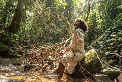 Side view of woman in forest