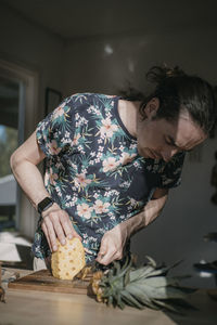 Man cutting pineapple