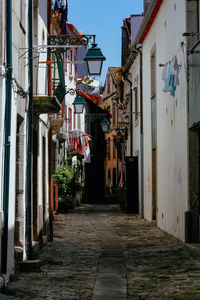 Narrow street amidst buildings in city