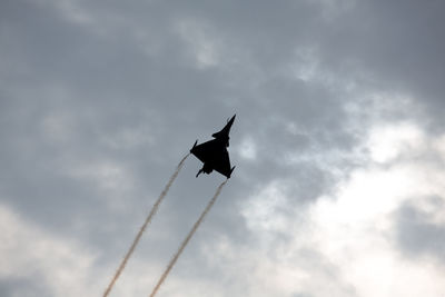 Low angle view of airplane flying against sky