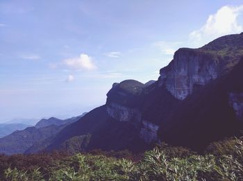 Scenic view of mountains against cloudy sky