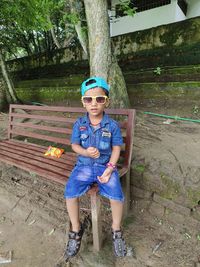 Portrait of boy sitting on field