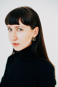 Portrait of young woman against white background