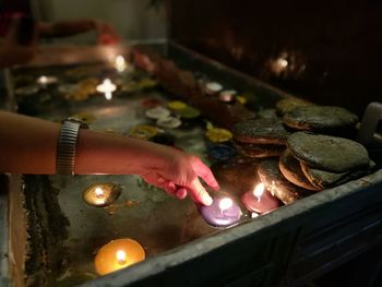 Close-up of hand holding illuminated lights