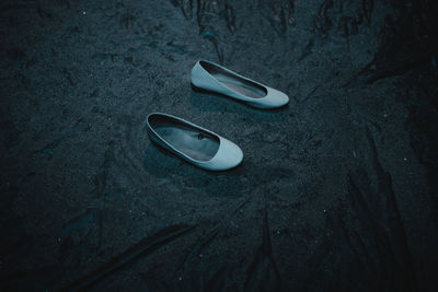 High angle view of shoes on beach