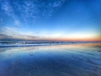 Scenic view of frozen sea against blue sky