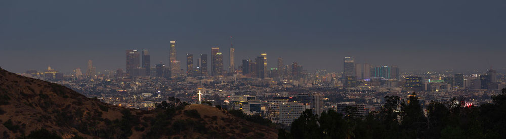 Skyline of los angeles at blue hour with a lighted cross in the foreground