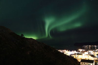 Scenic view of illuminated mountains against sky at night