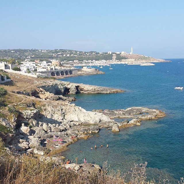 sea, water, clear sky, built structure, architecture, building exterior, blue, copy space, nautical vessel, horizon over water, beach, high angle view, transportation, rock - object, coastline, shore, city, nature, day, scenics