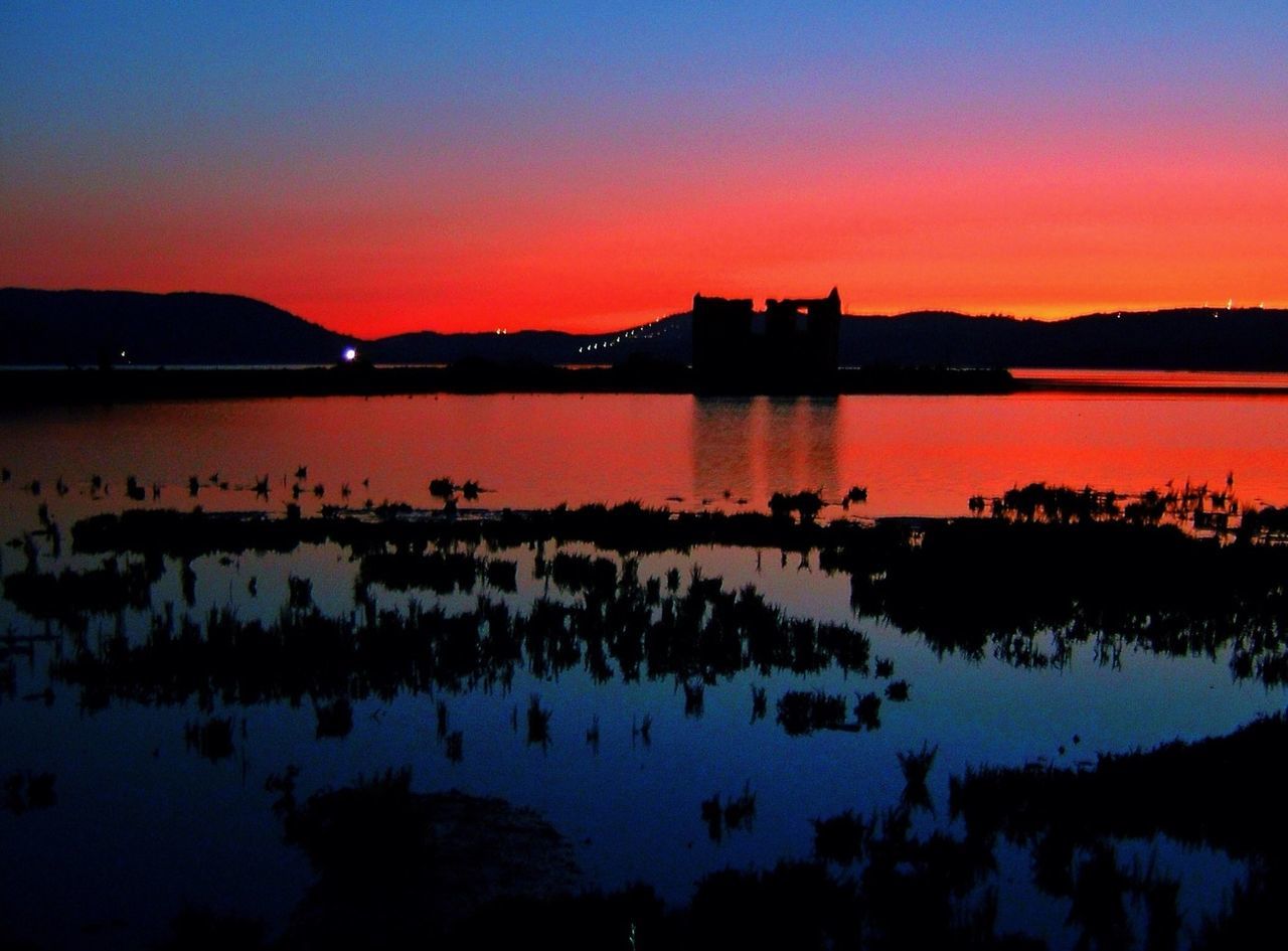 sunset, reflection, water, silhouette, orange color, lake, tranquil scene, scenics, tranquility, beauty in nature, sky, dusk, idyllic, mountain, standing water, nature, clear sky, illuminated, copy space, calm