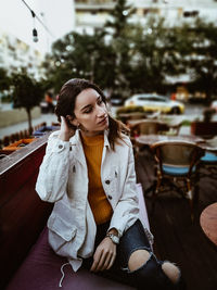 Young woman sitting at cafe