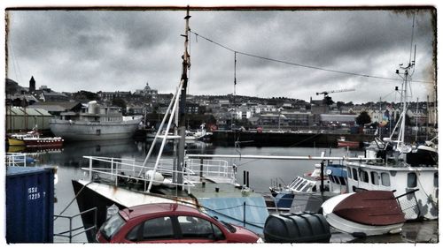 View of harbor against cloudy sky