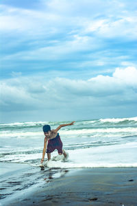 Man standing on beach against sky